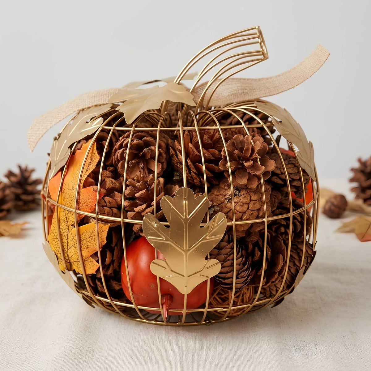Cinnamon scented pumpkin potpourri with decorative gold leaves and ribbon