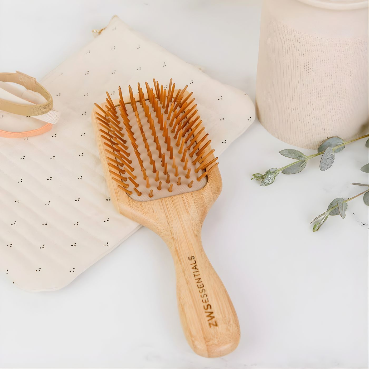 Eco friendly bamboo hair brush on cosmetic bag