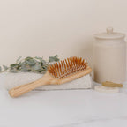 Eco friendly bamboo hair brush on hand towel