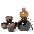 Black and brown Japanese sake set with bottle and four ceramic cups