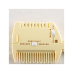 Flat lay of KAI Winnie the Pooh Comb Shaper showing cute yellow design and smooth rounded tip