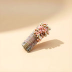 Close-up of wildflowers on white sage smudge stick - pink