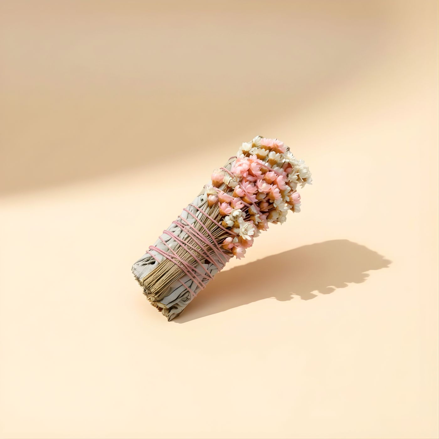Close-up of wildflowers on white sage smudge stick - pink