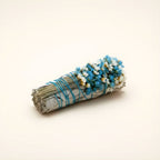 Close-up of wildflowers on white sage smudge stick - aqua