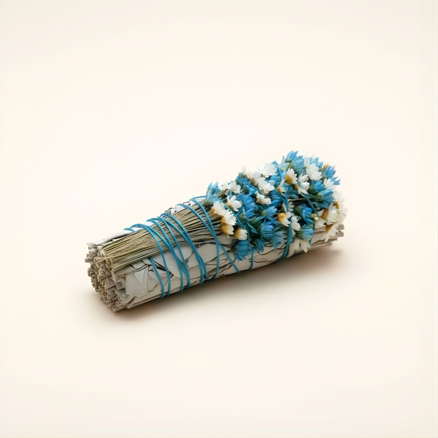 Close-up of wildflowers on white sage smudge stick - aqua
