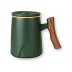 Porcelain tea mug with infuser and lid in deep green with wood handle