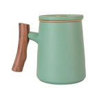 Green porcelain tea cup with infuser and wood-look handle