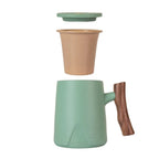 Green ceramic tea mug with infuser and lid separated