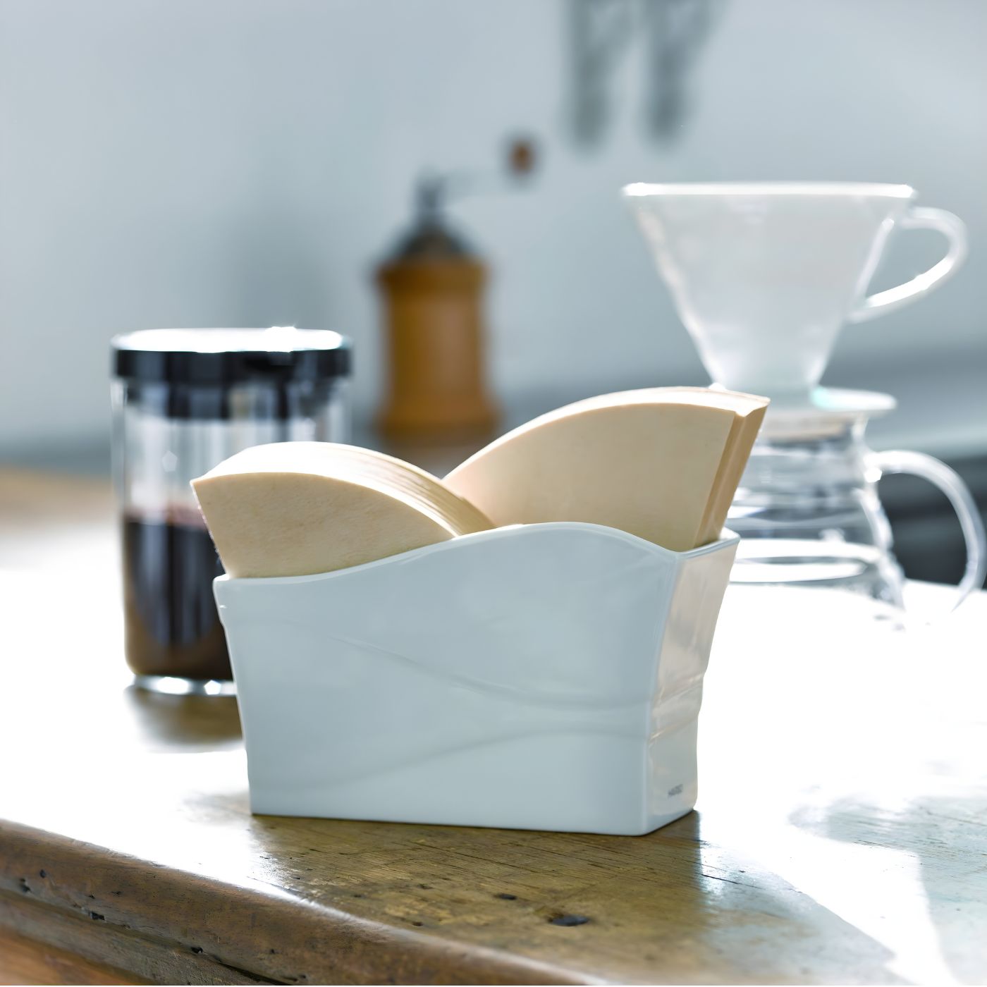 Ceramic paper filter stand styled on kitchen counter with pour over coffee setup