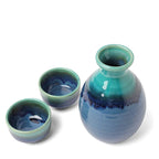 Ceramic sake bottle 10 oz in ocean blue glaze with two ceramic cups top view