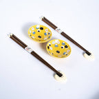Yellow onigiri sauce dishes with rice ball chopstick rests