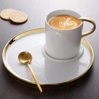 Cappuccino cup and saucer filled with cappuccino and cookies