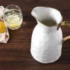 Porcelain jug with gold trim water pitcher on dining table