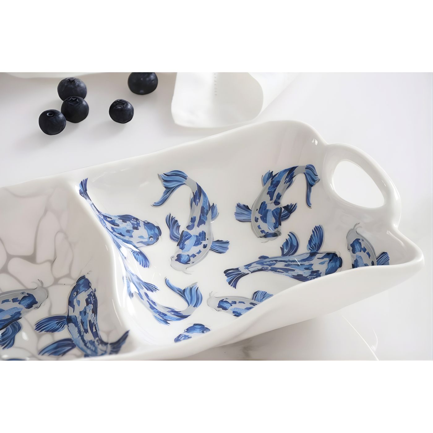 Close-up of koi artwork on melamine serveware