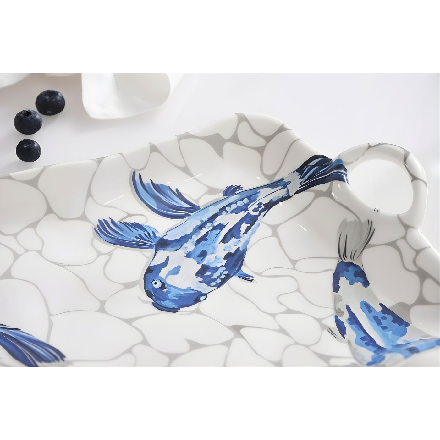 Close-up of koi artwork on melamine serving dish