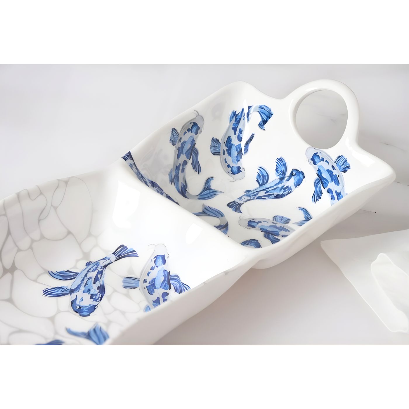 Close-up of blue koi artwork on melamine chip and dip platter