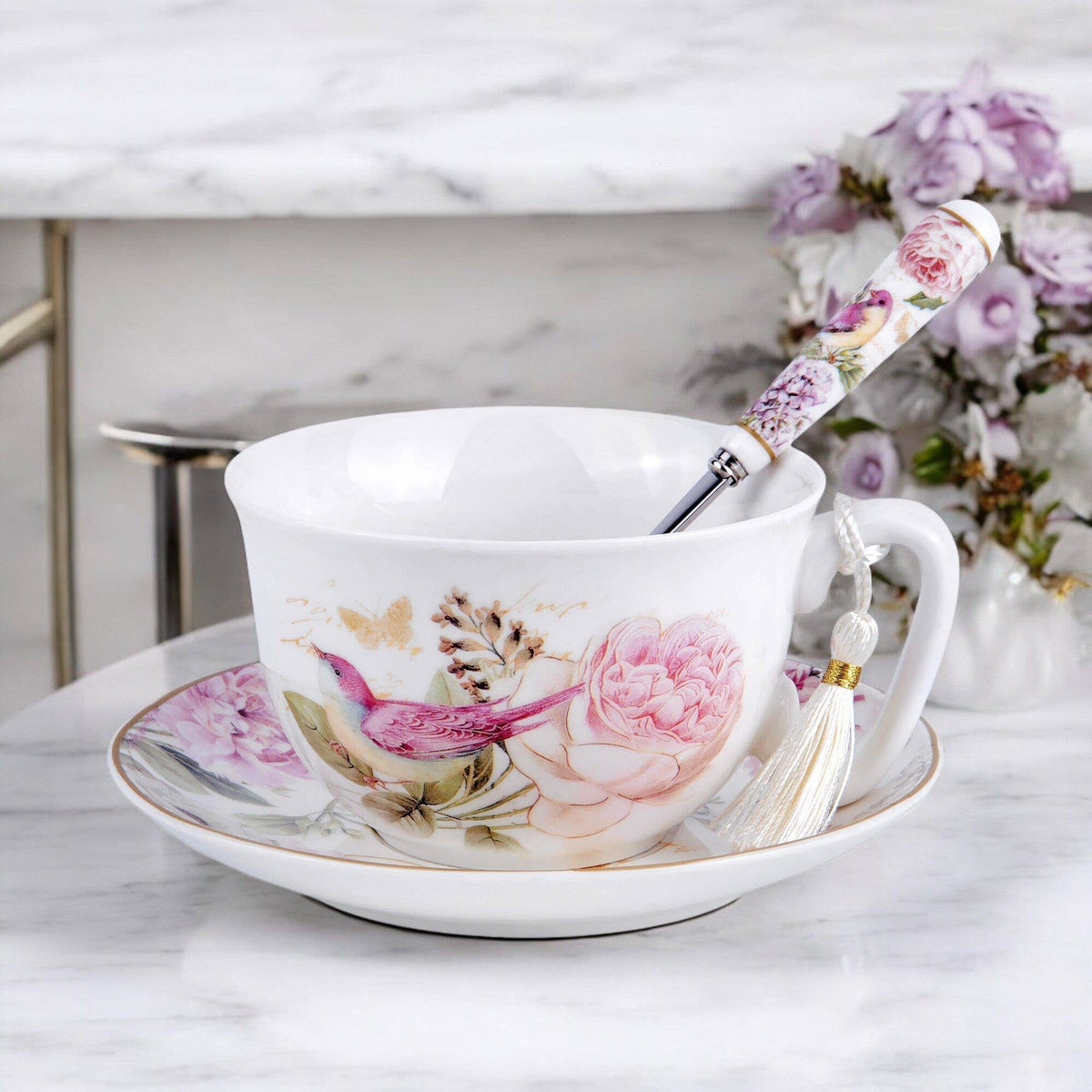 Floral tea cup and saucer with peonies and birds