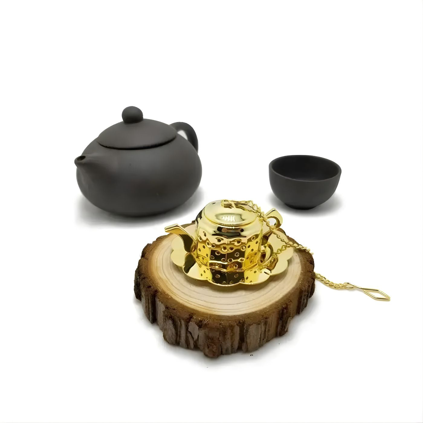 Mini gold teapot tea strainer on a log coaster