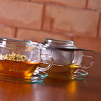 Loose leaf tea steeping in glass cup with steel strainer 2