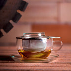 Trendglas Jena glass tea cup with stainless steel strainer at workstation