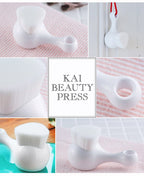Multiple views of Kai High Density Facial Cleansing Brush showing ergonomic handle, hanging loop, and dense bristle head.