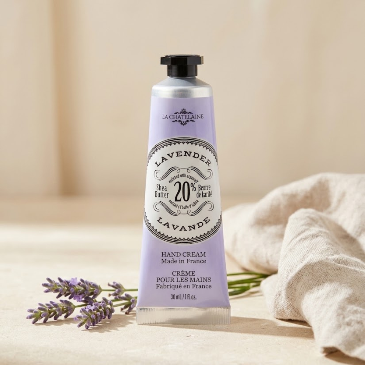 La Chatelaine Lavender Hand Cream with 20% shea butter, organic argan oil, and vitamin E with background