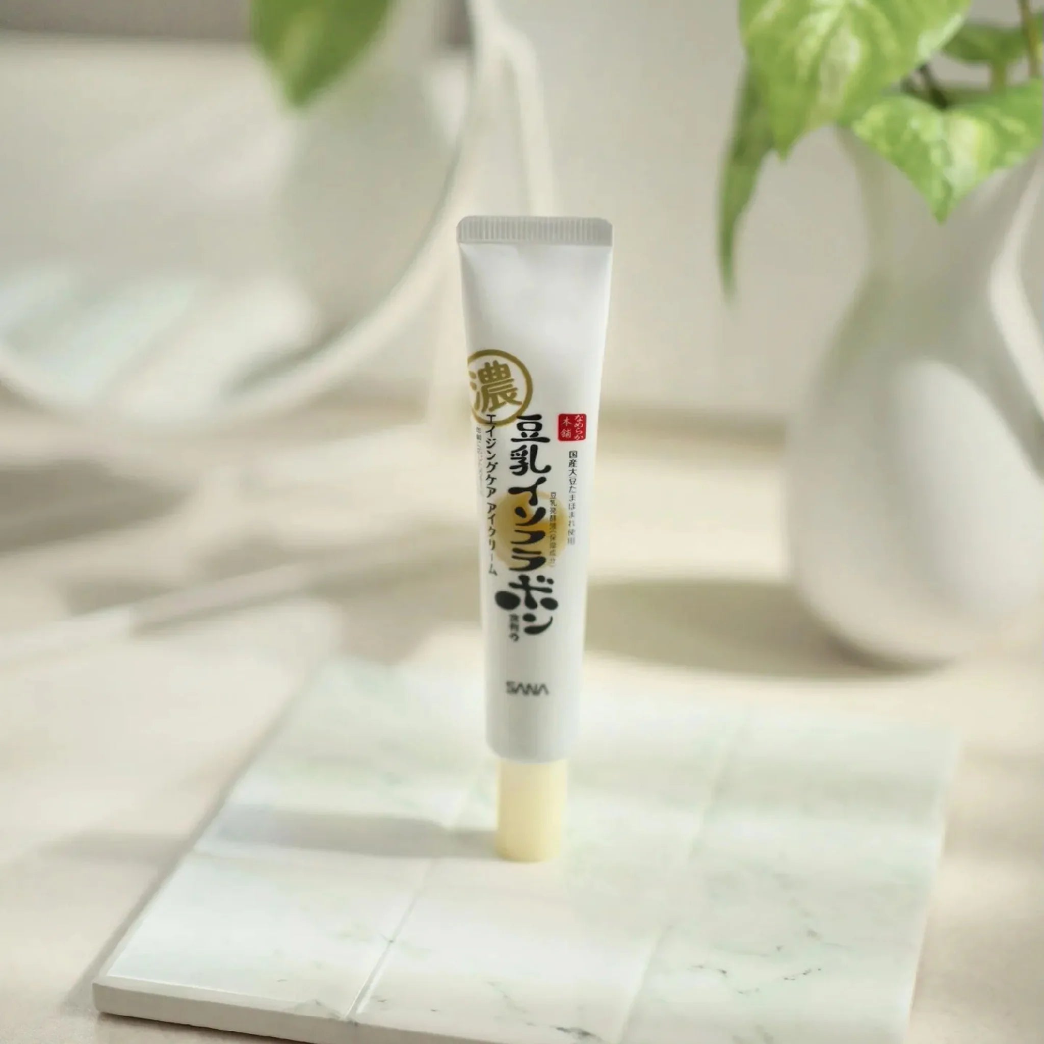 ANA Nameraka Wrinkle Eye Cream – Japanese soy milk and retinol eye care cream displayed on a marble surface in soft natural light