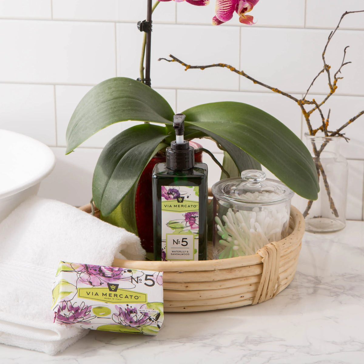 Via Mercato Waterlily & Sandalwood hand soap beside a bathroom sink